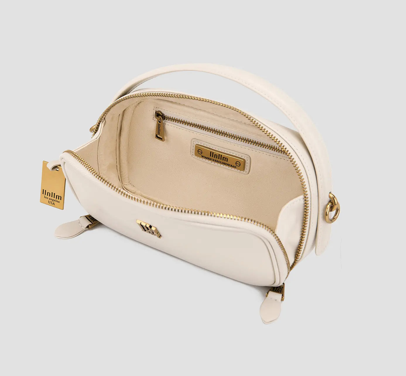 White leather mini crossbody bag with suede beige interior and gold zipper – designer small purse for women.