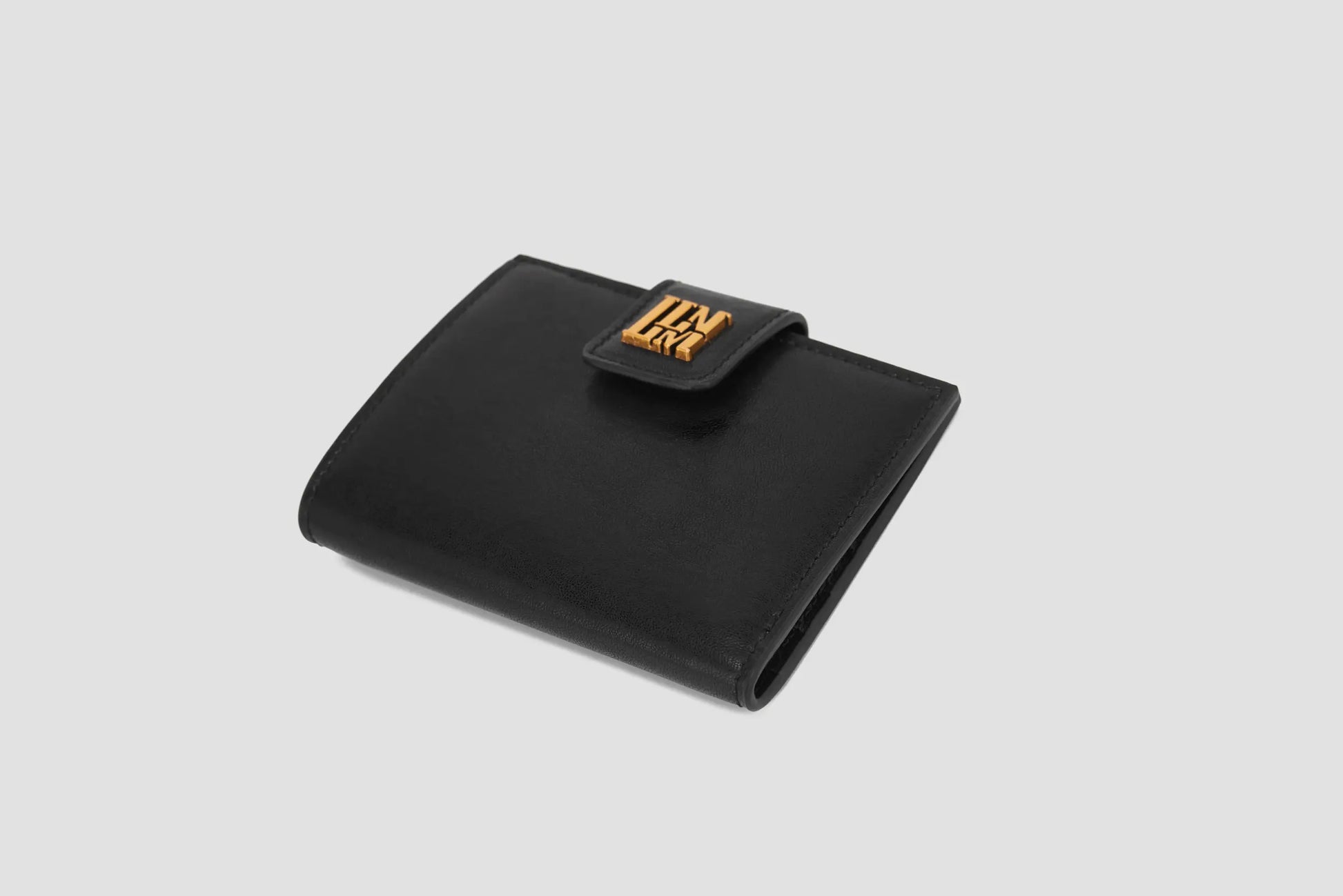 Black leather llnllm women’s wallet with gold logo clasp, compact and elegant.