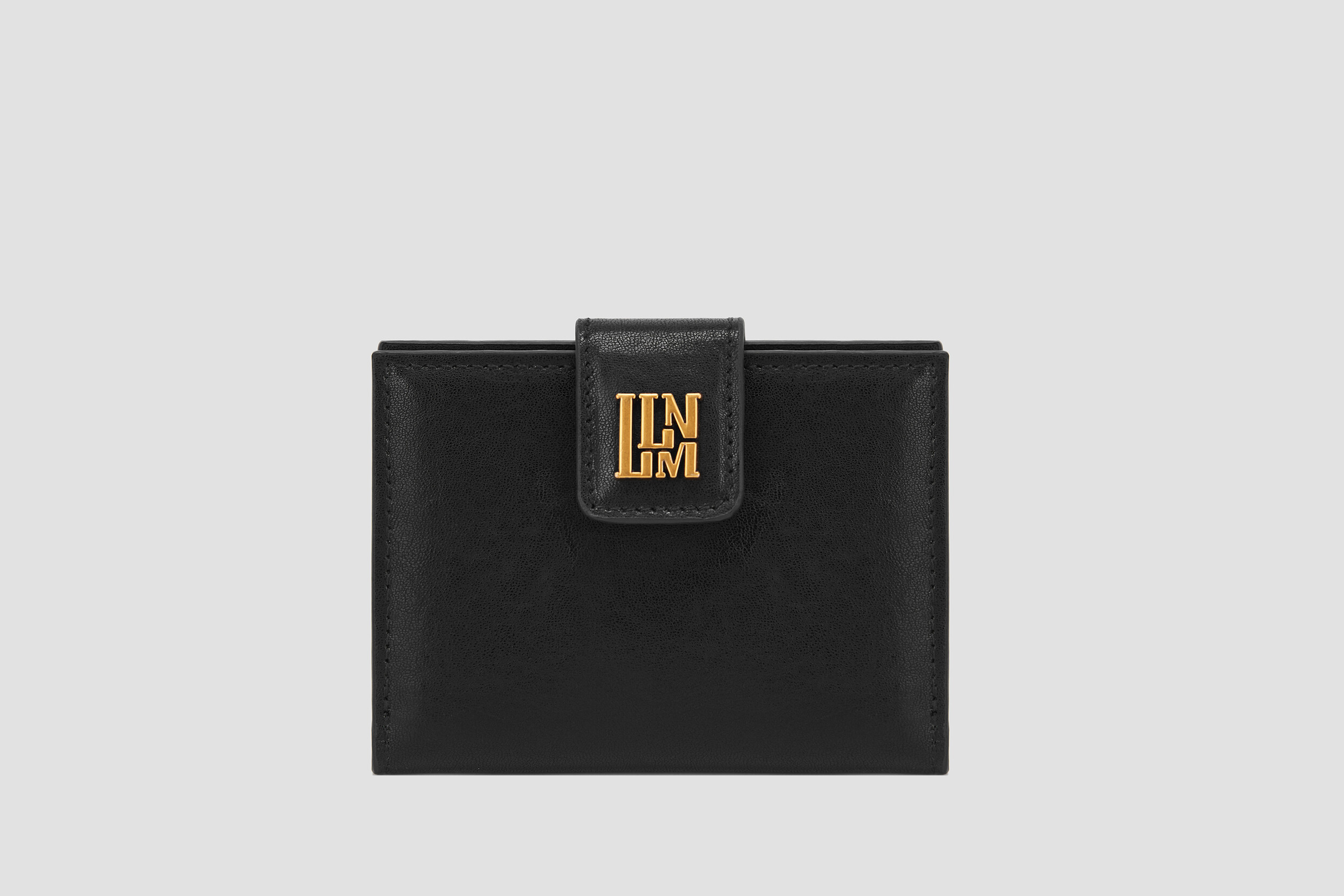 Black leather women’s wallet with gold logo clasp, compact and elegant.