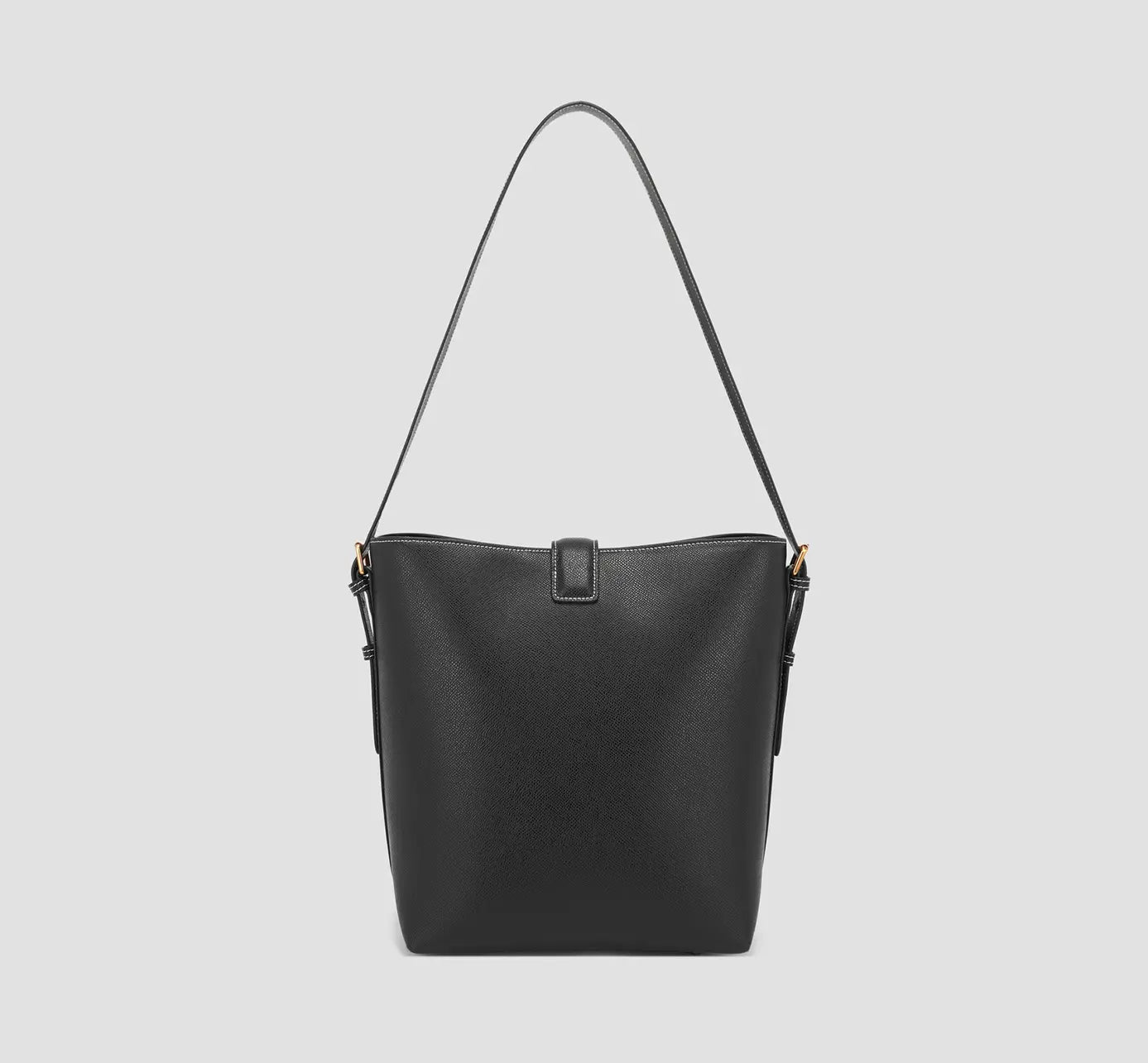 Back View of Rear view of matte black tote bag with minimal detailing and smooth, polished leather surface.
