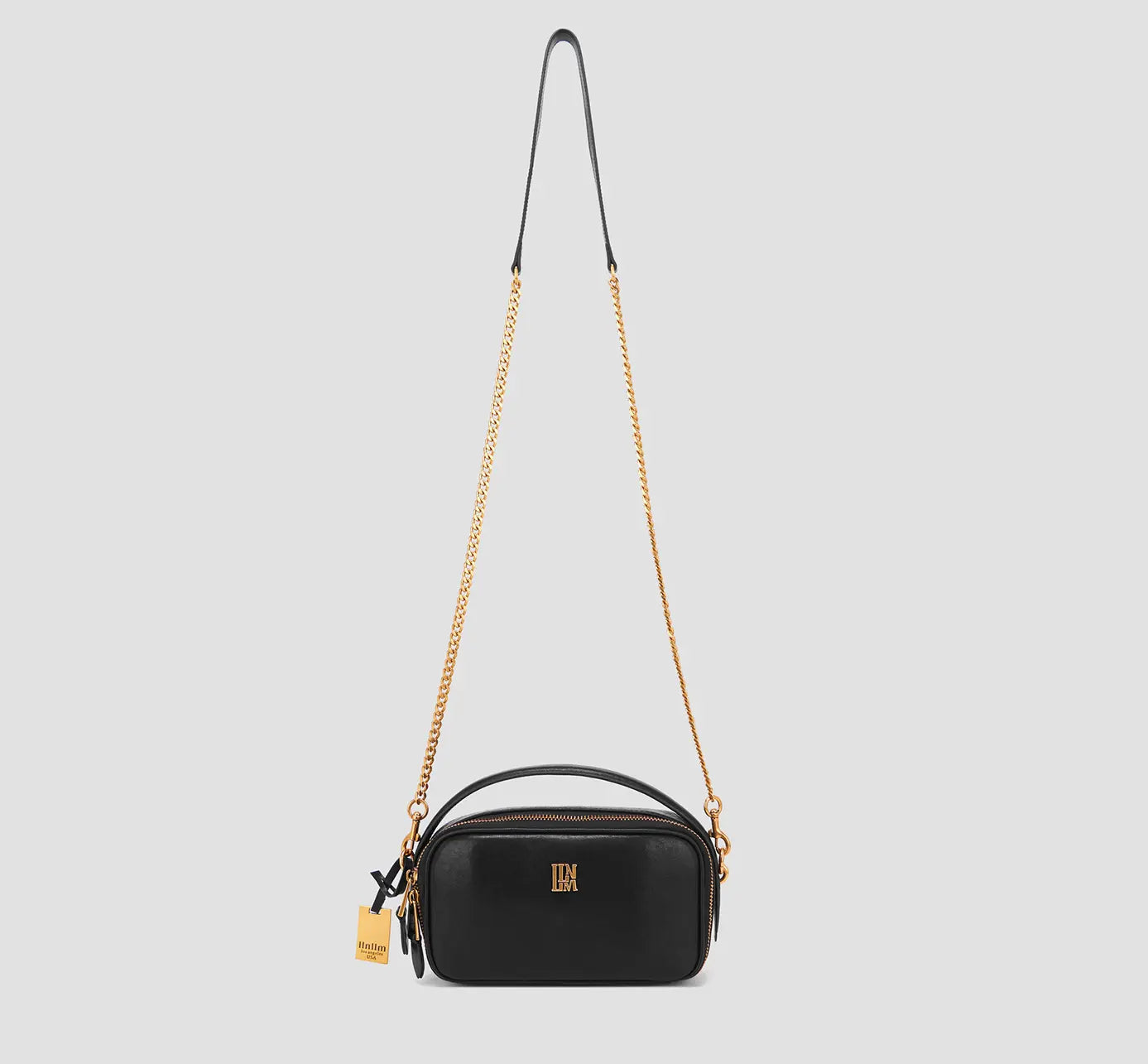 Elegant black leather crossbody bag for women with gold chain strap and top handle – luxury mini purse for daily wear or night out.