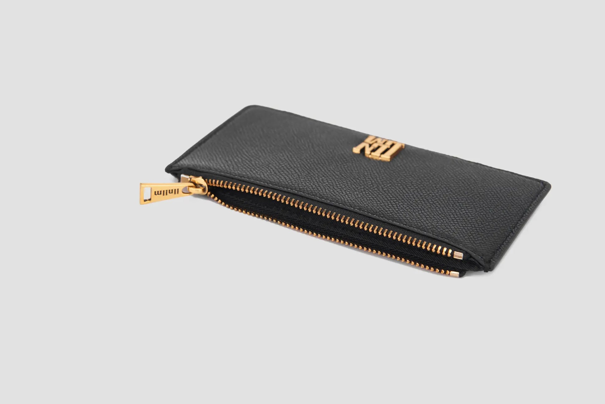 The angled view of black llnllm card holder showing gold zipper detail.