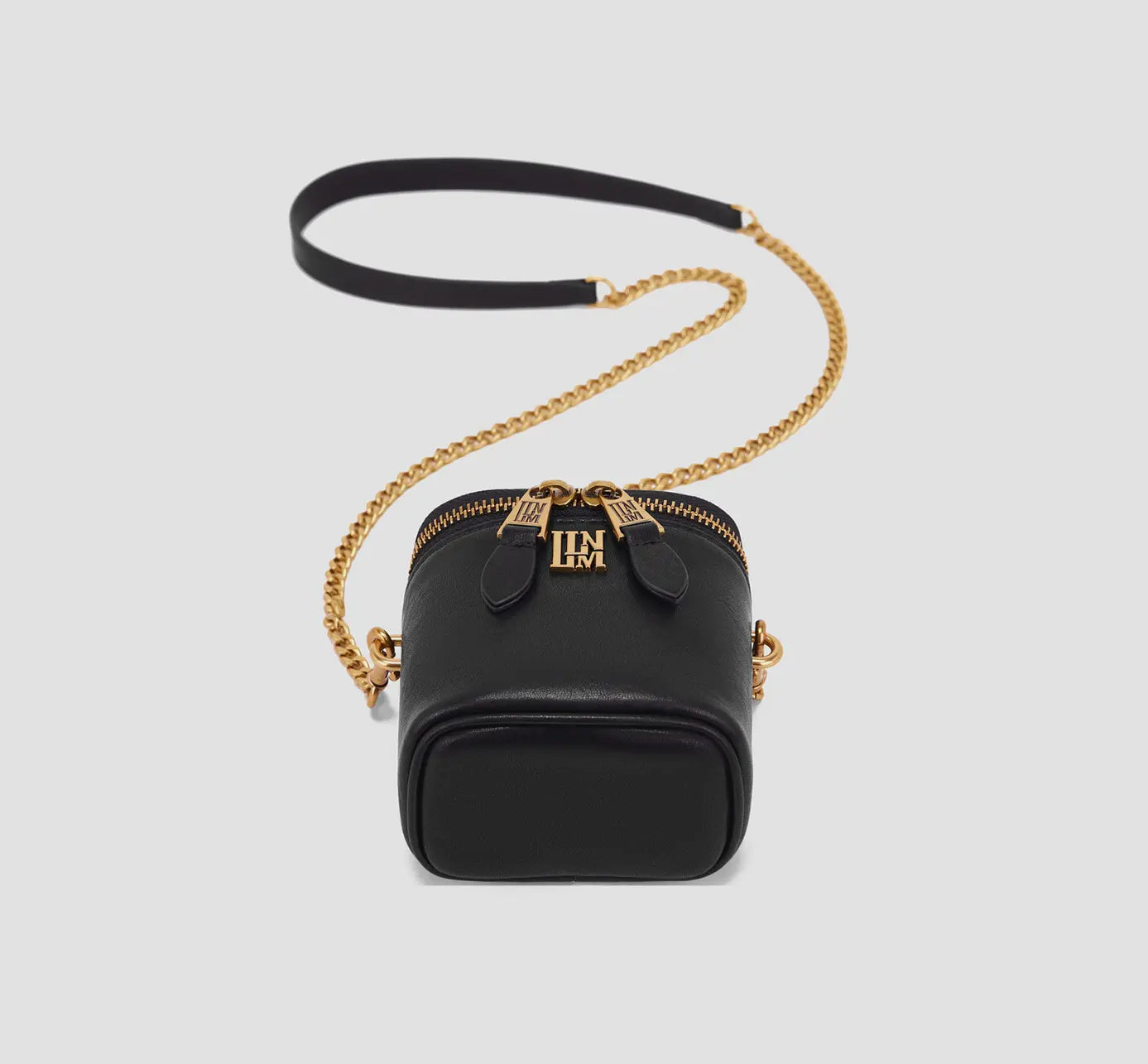 The Angled top view of structured black leather crossbody purse with double zipper and long chain strap for women.
