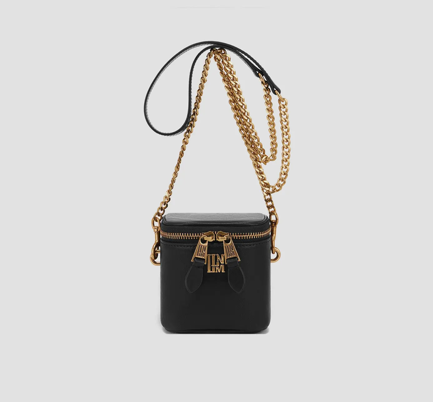 The front view of black mini crossbody bag with gold chain strap and luxury zipper detail, trendy box purse.
