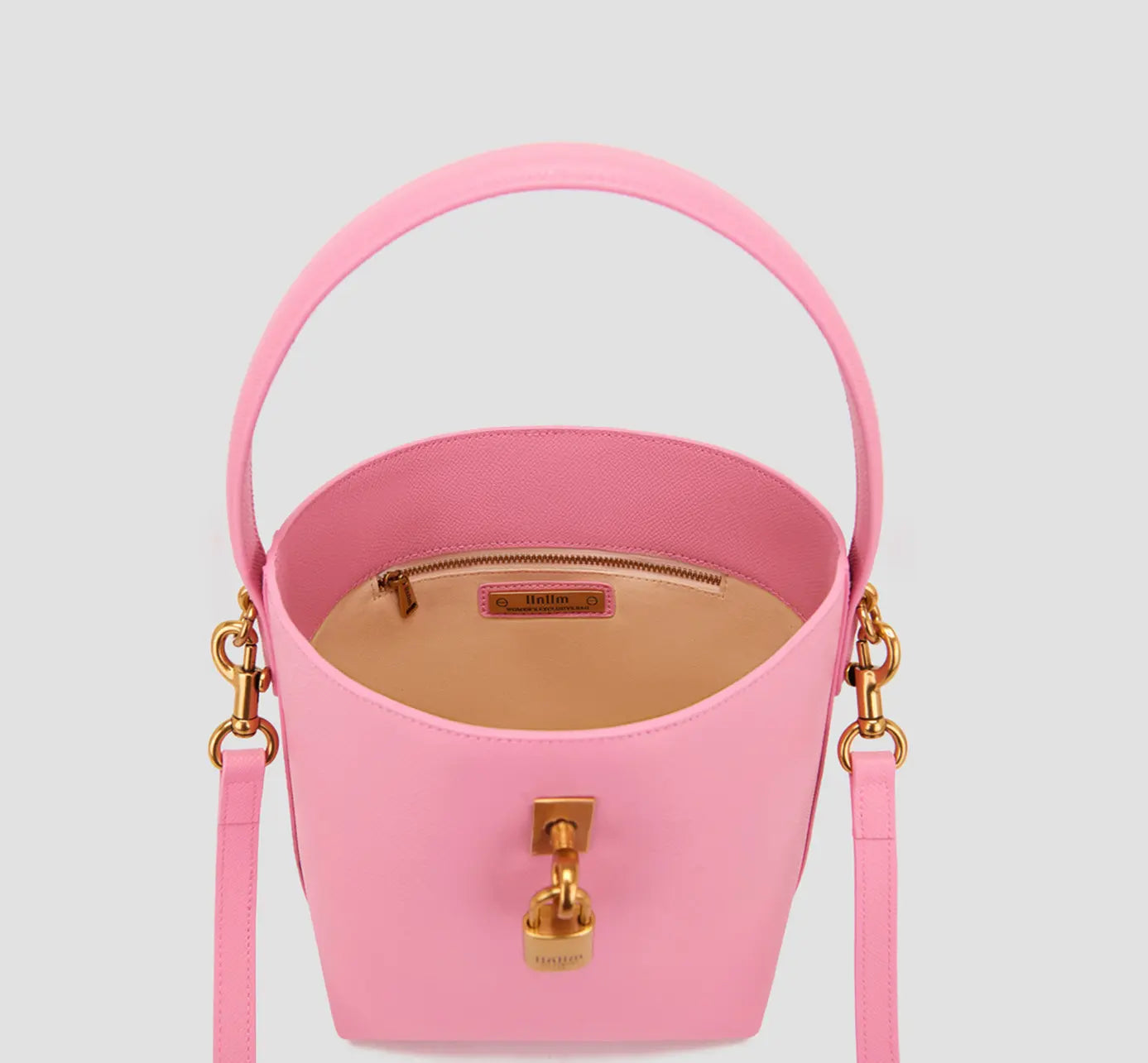 The inside view of pink women’s bucket purse with secure zip pocket and luxury suede lining.
