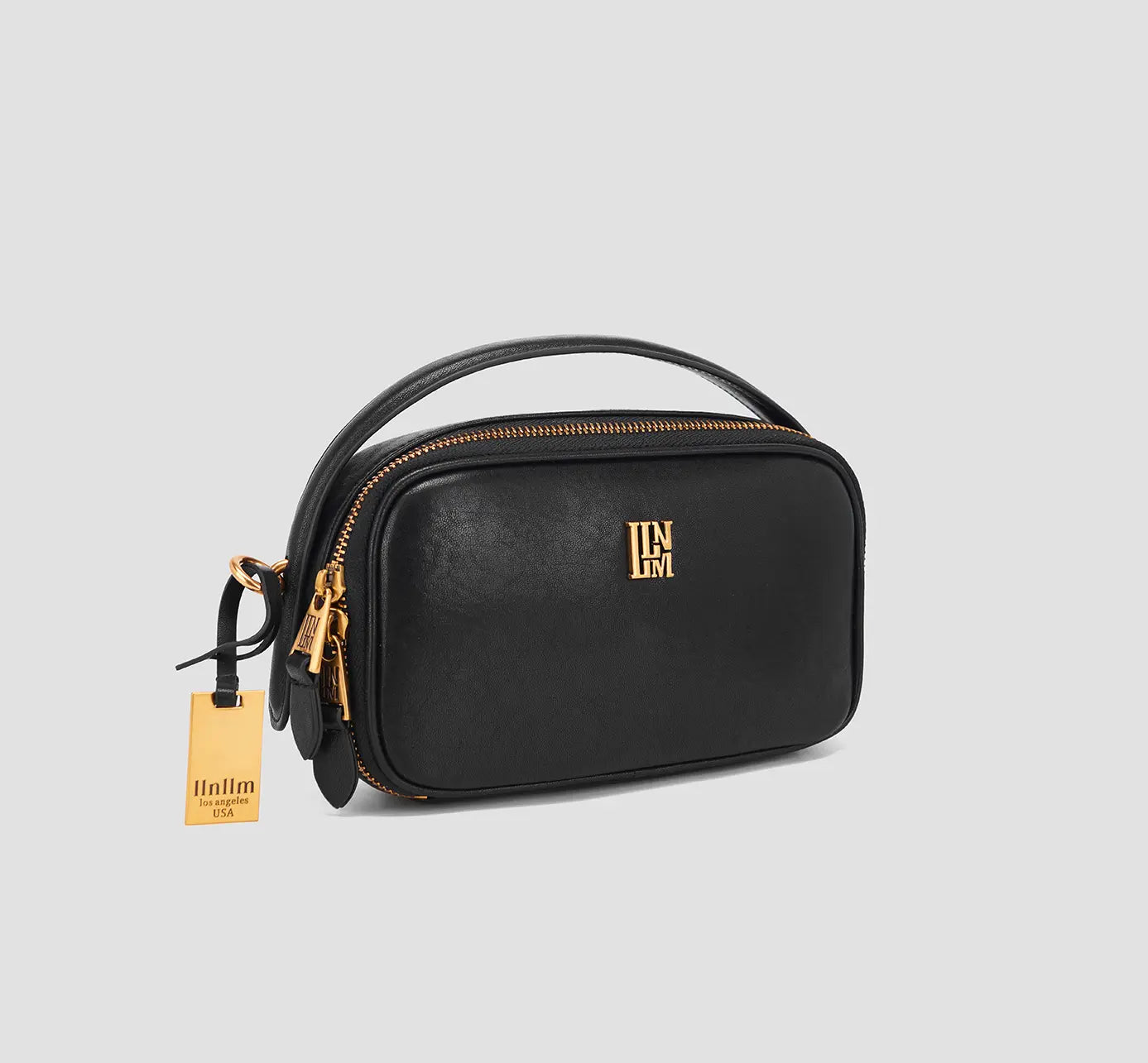 The angled view of black mini purse with zipper and chain detail- Chic small black crossbody purse with top zipper and designer chain – best black evening bag for ladies.
