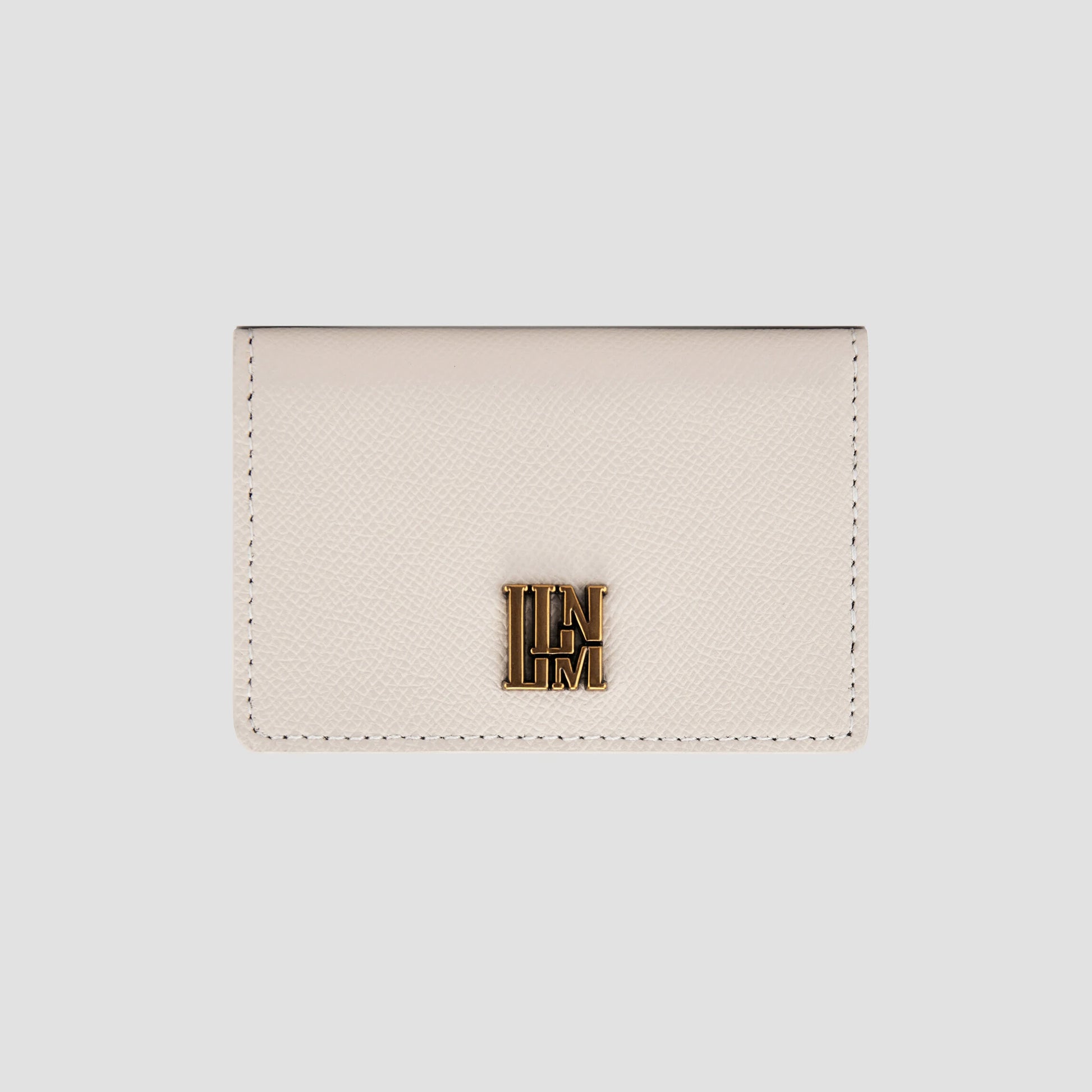 Front view of white  wallet with gold logo detail.
