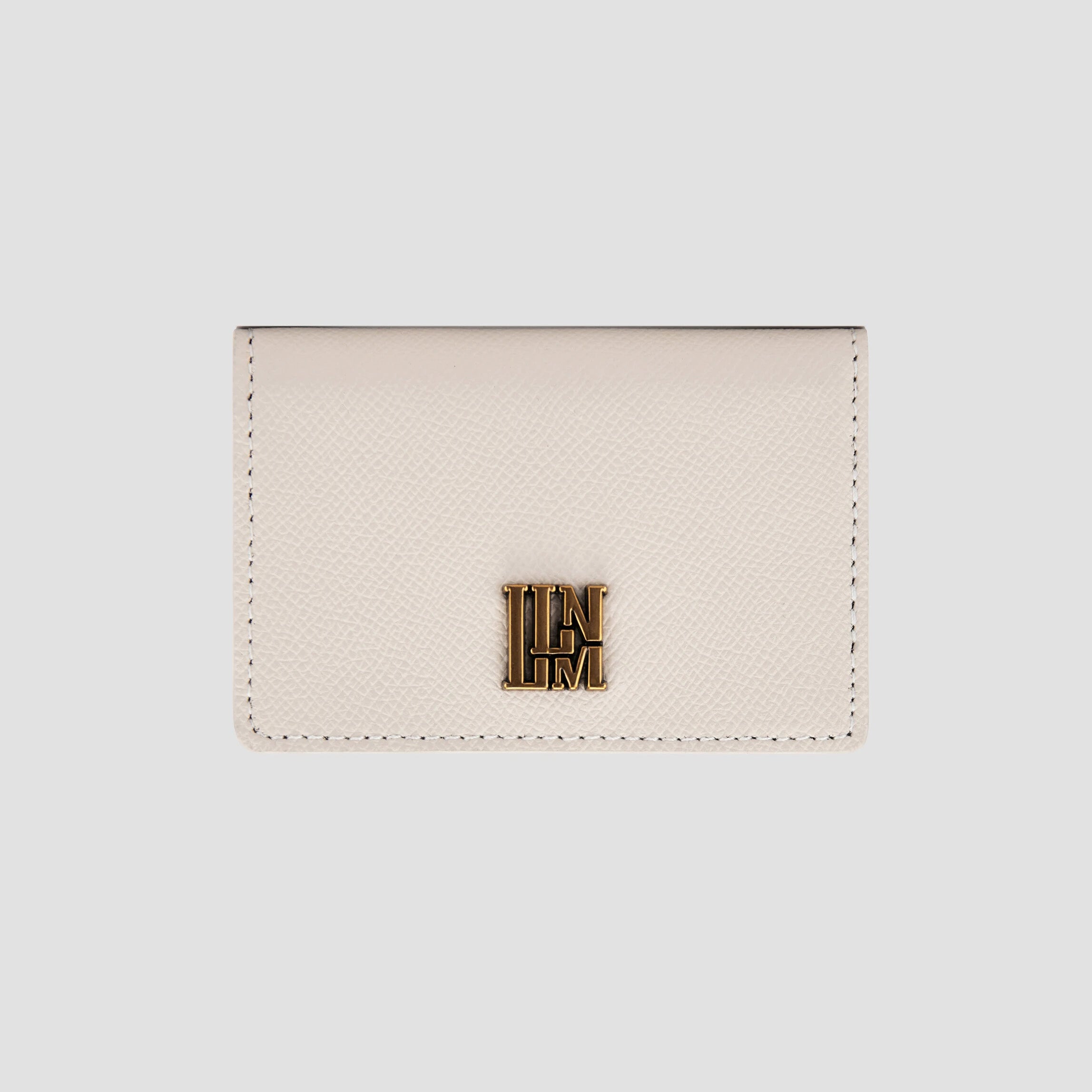 Front view of white  wallet with gold logo detail.