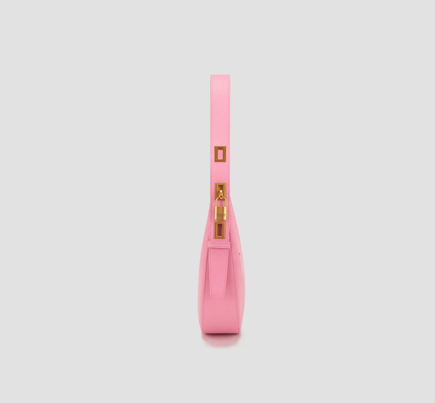 The side view of designer pink hobo bag with wide strap and decorative gold buckle lock – Y2K fashion purse.