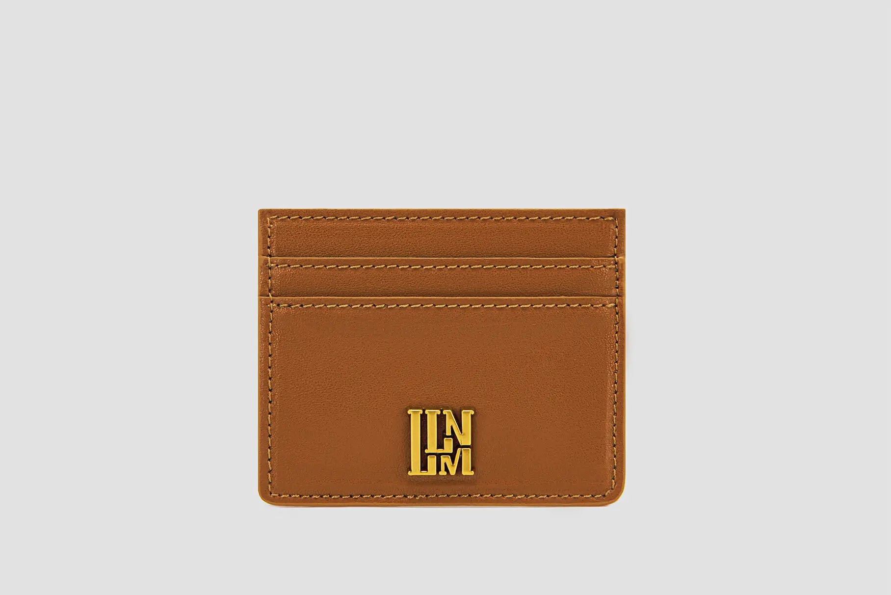 Tan leather llnllm slim card holder with gold logo, classic style.