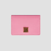 Front view of pink llnllm wallet with gold logo accent.