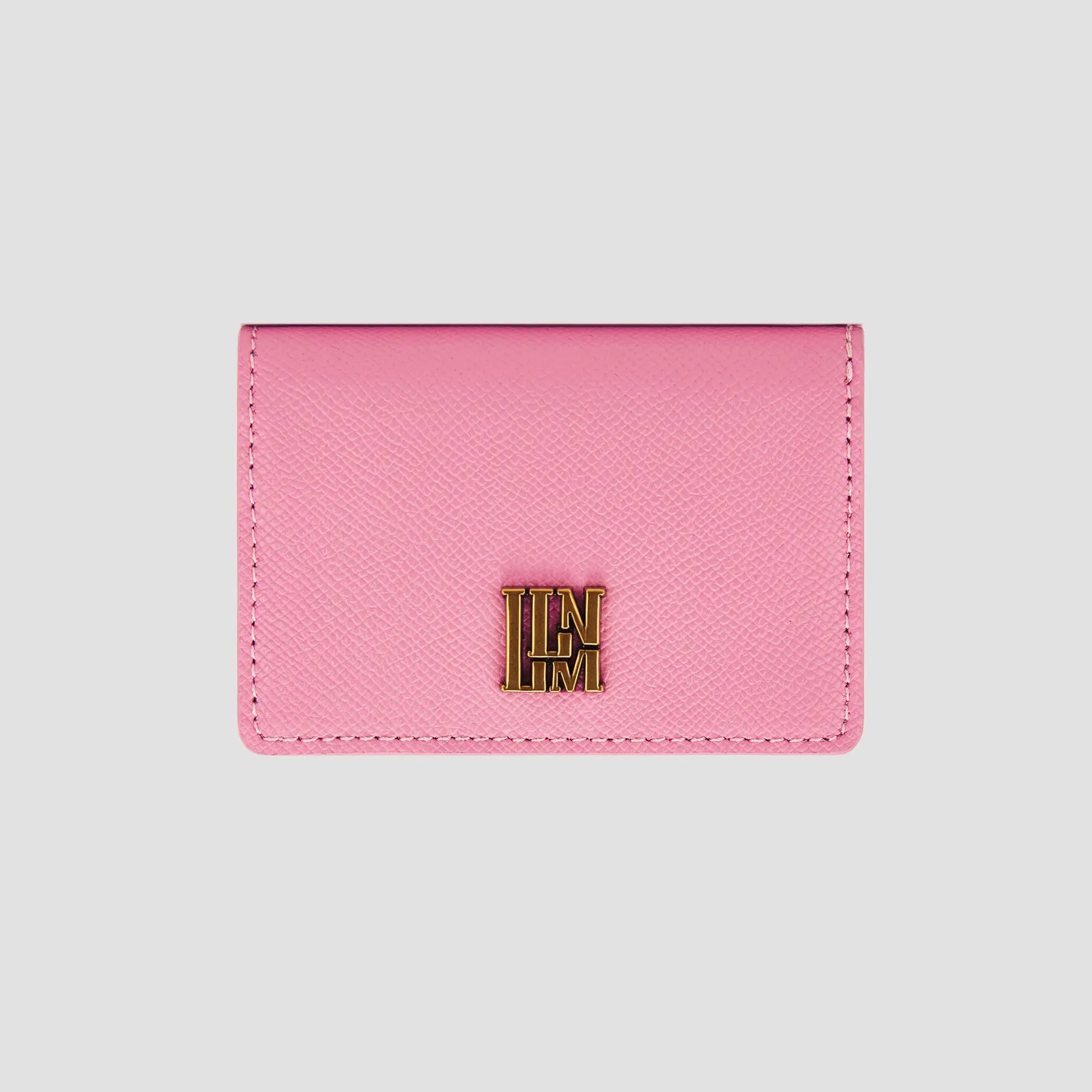 Front view of pink llnllm wallet with gold logo accent.