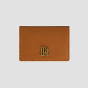 Front view of tan wallet with gold logo detail.