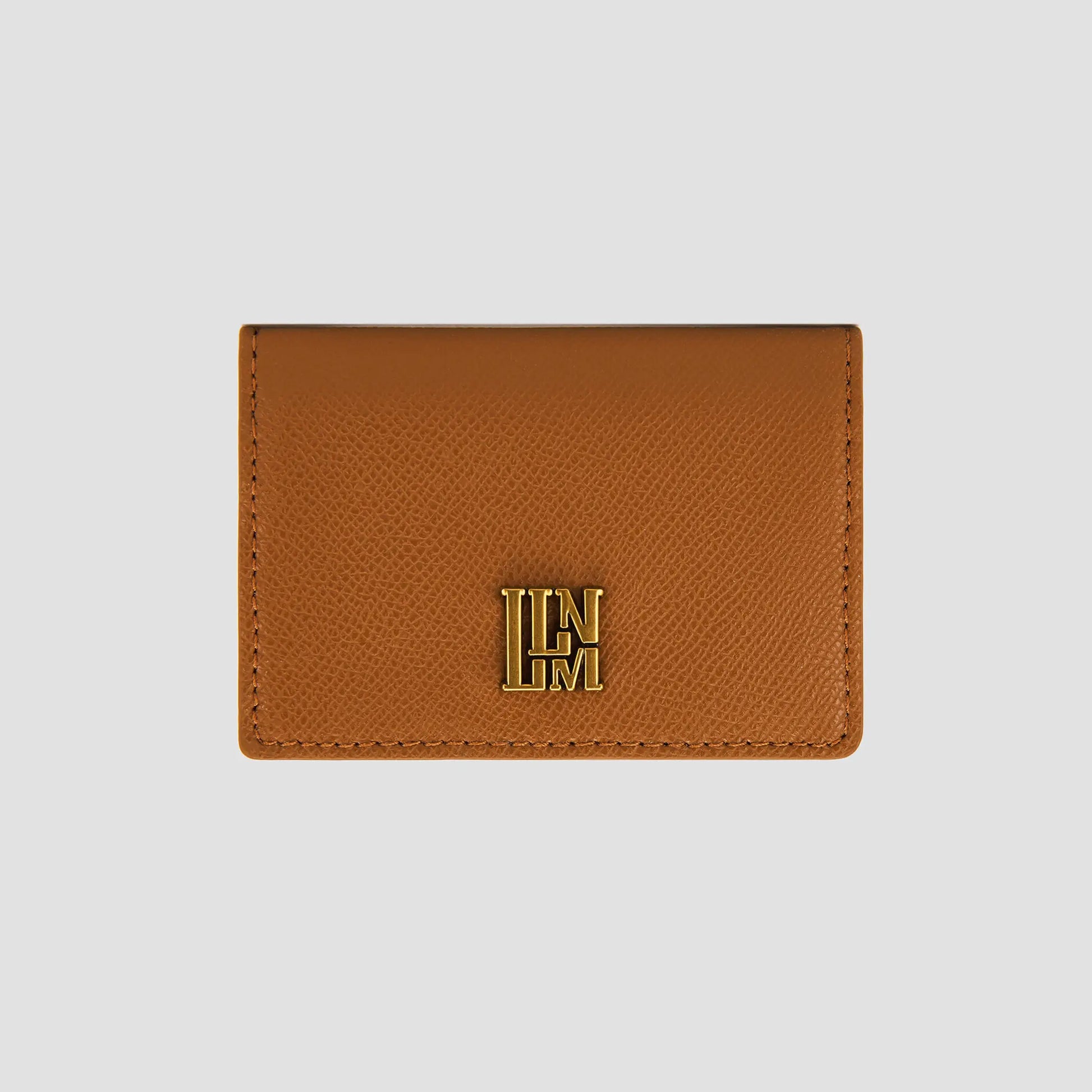 Front view of tan wallet with gold logo detail.