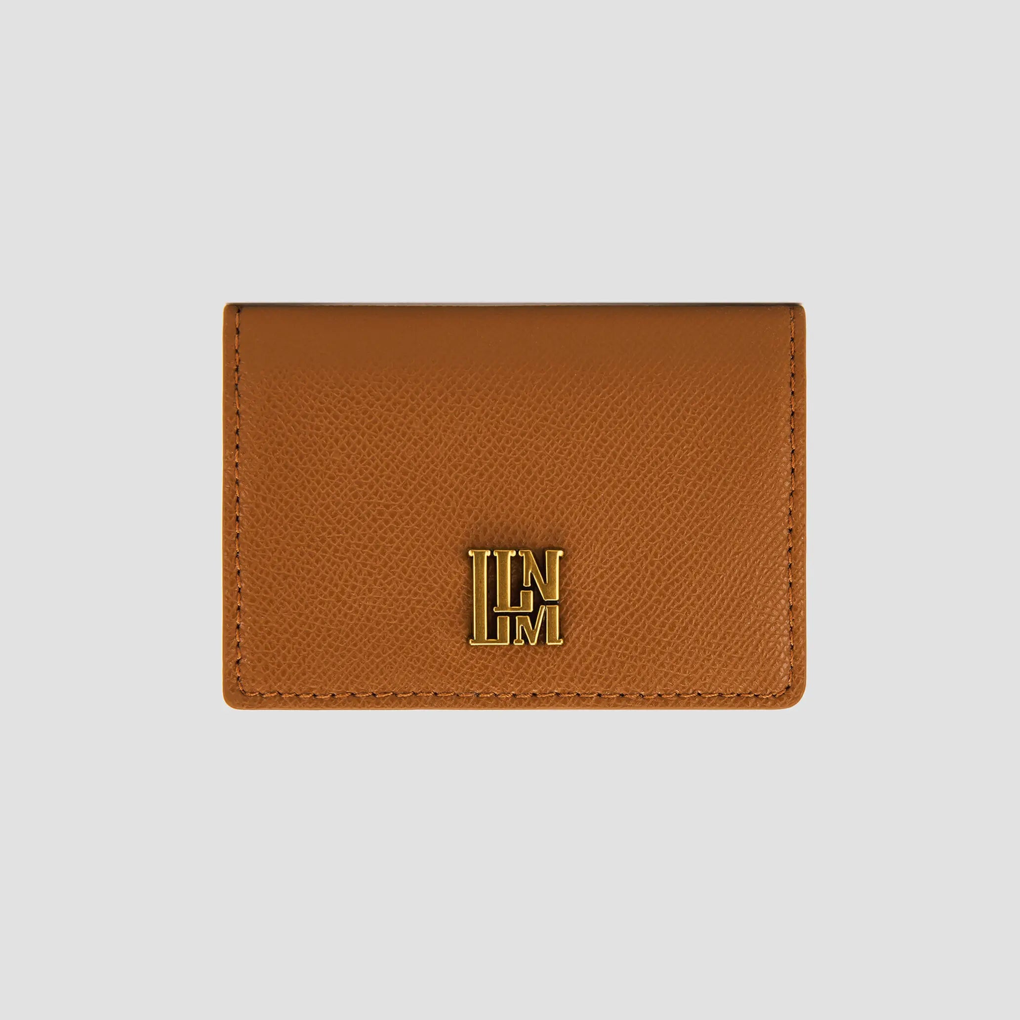 Front view of tan wallet with gold logo detail.