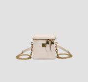This is the front view of a white mini box purse with a gold zipper and chain strap, a compact crossbody bag for women.
