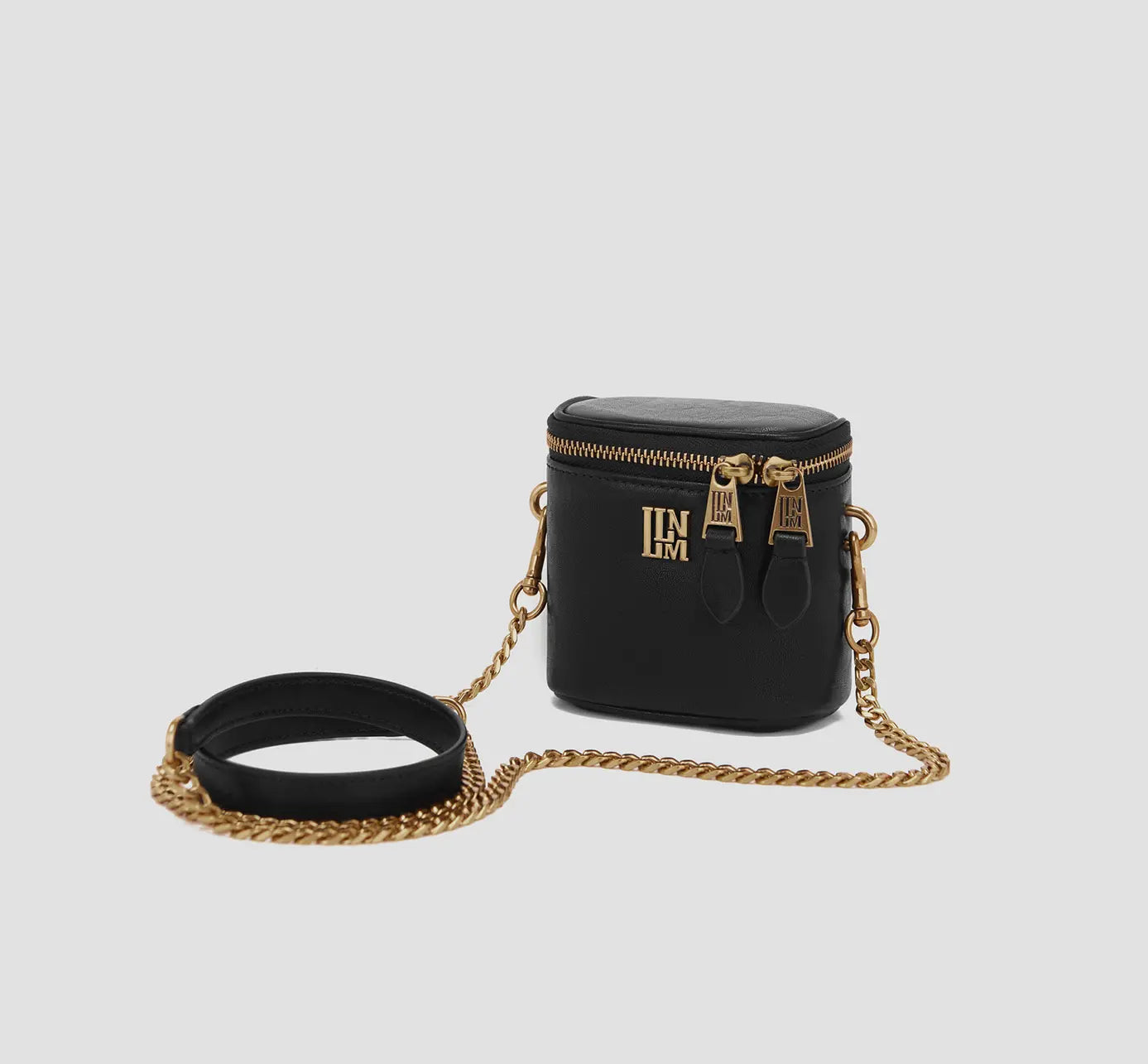The side view of minimalist black mini shoulder bag with round base and chain strap, tiny shoulder purse.

