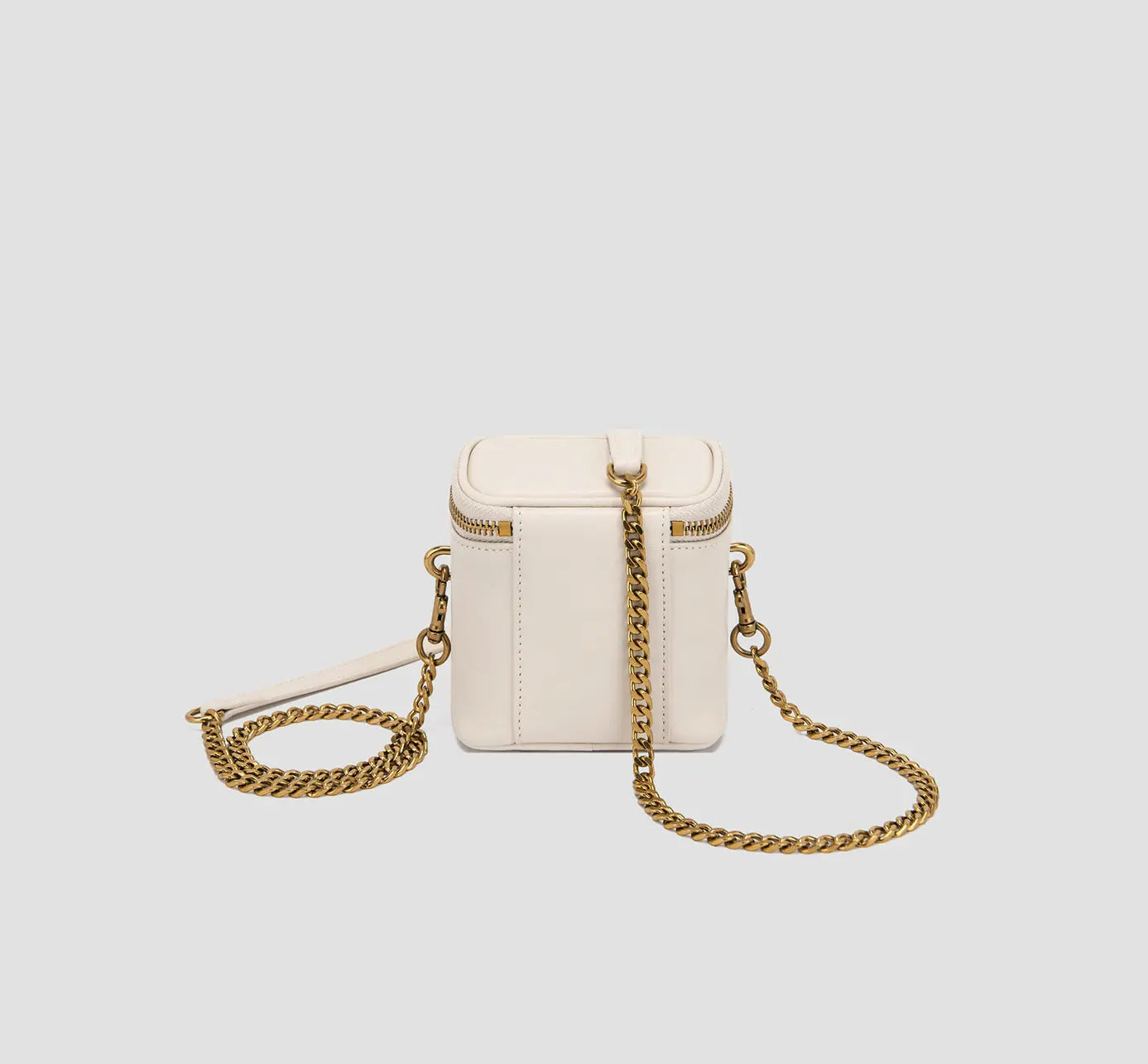 The back view of ivory mini crossbody bag with sleek leather finish and detachable strap.