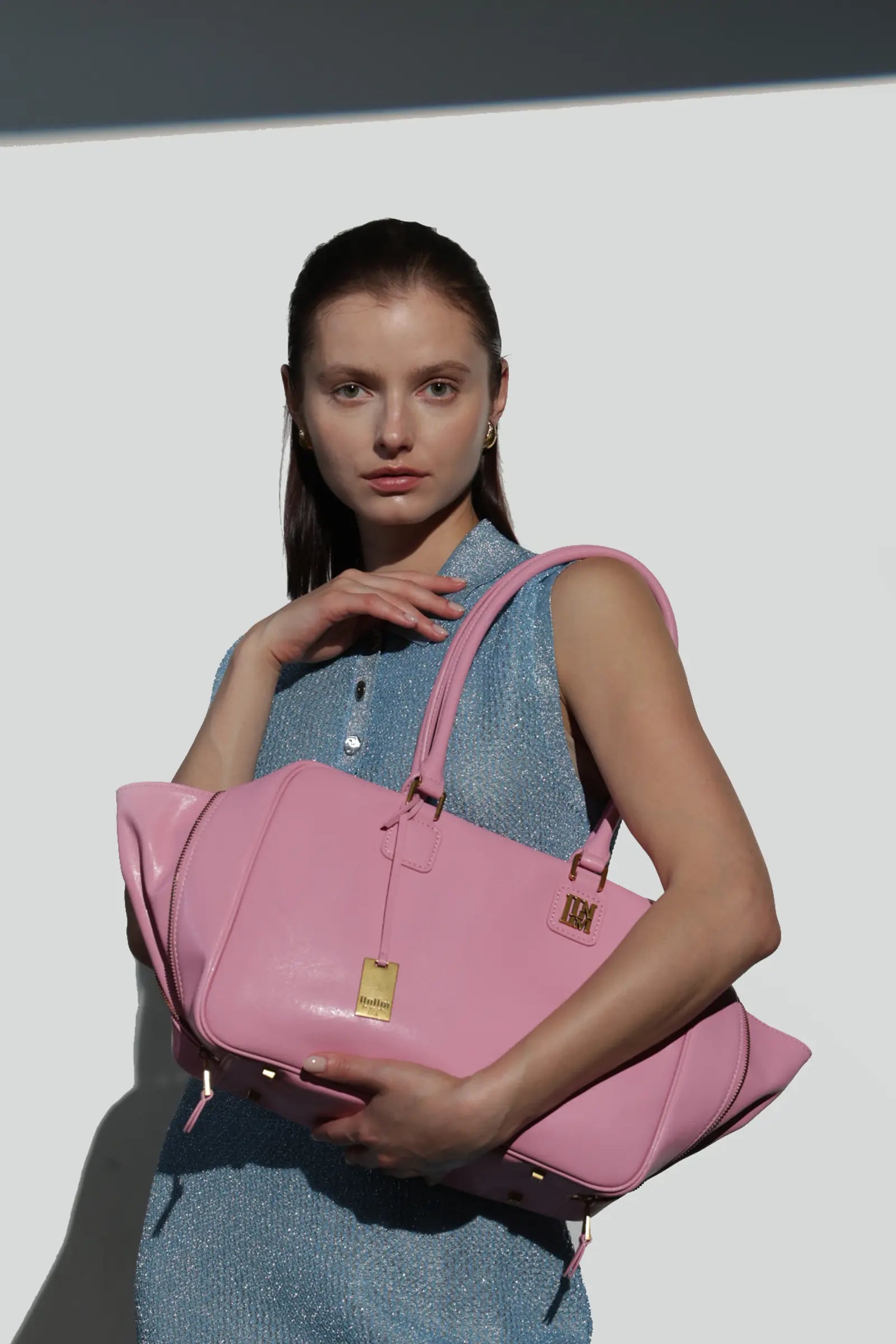 Woman holding a pink handbag