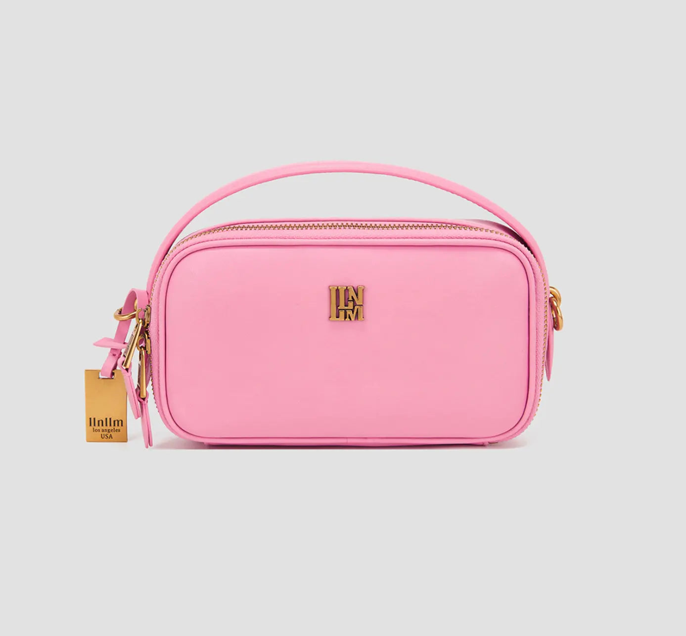 The front view of the soft pink vegan leather purse with a top handle – women’s designer mini handbag.