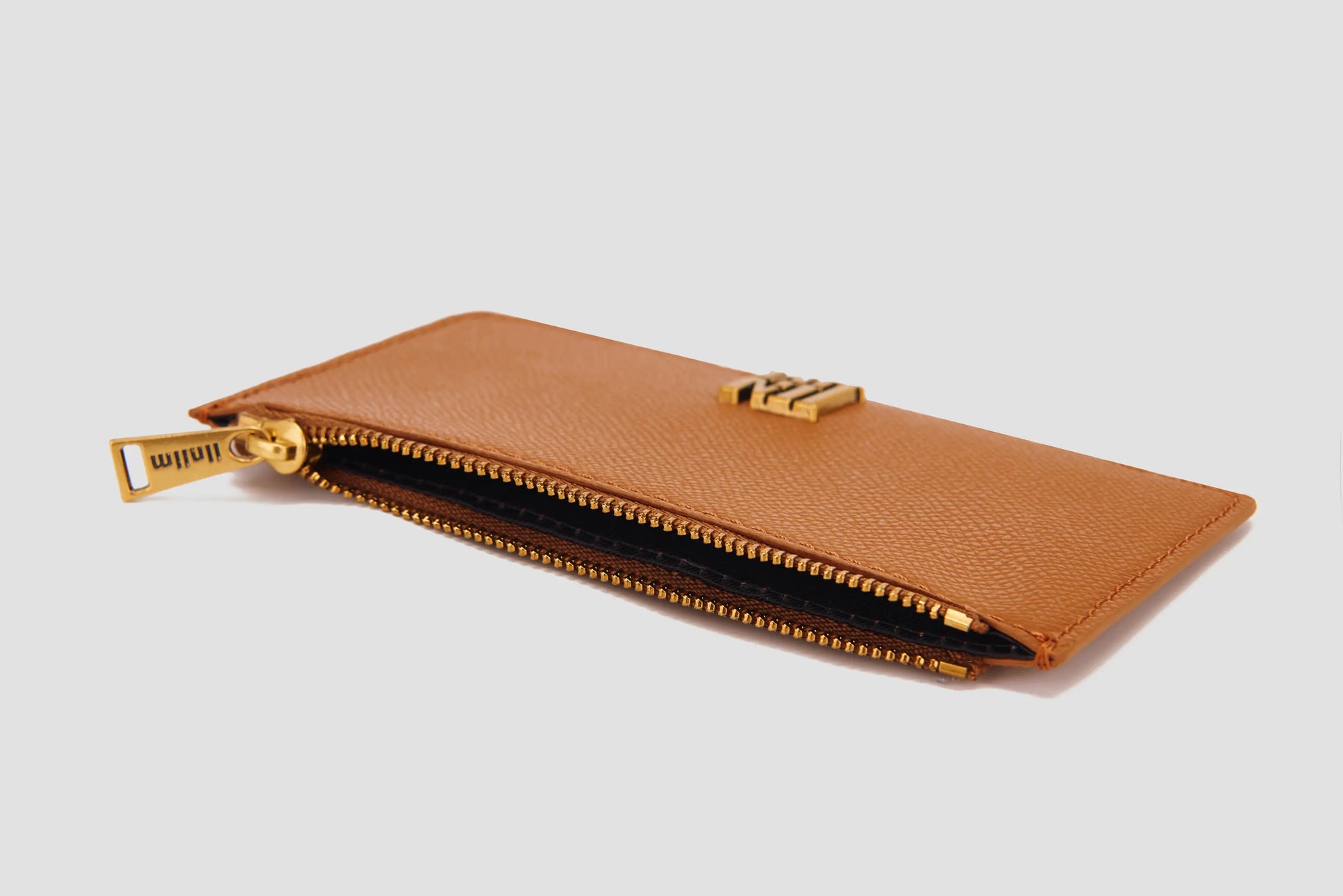 The angled view of tan llnllm card holder with zipper pocket.