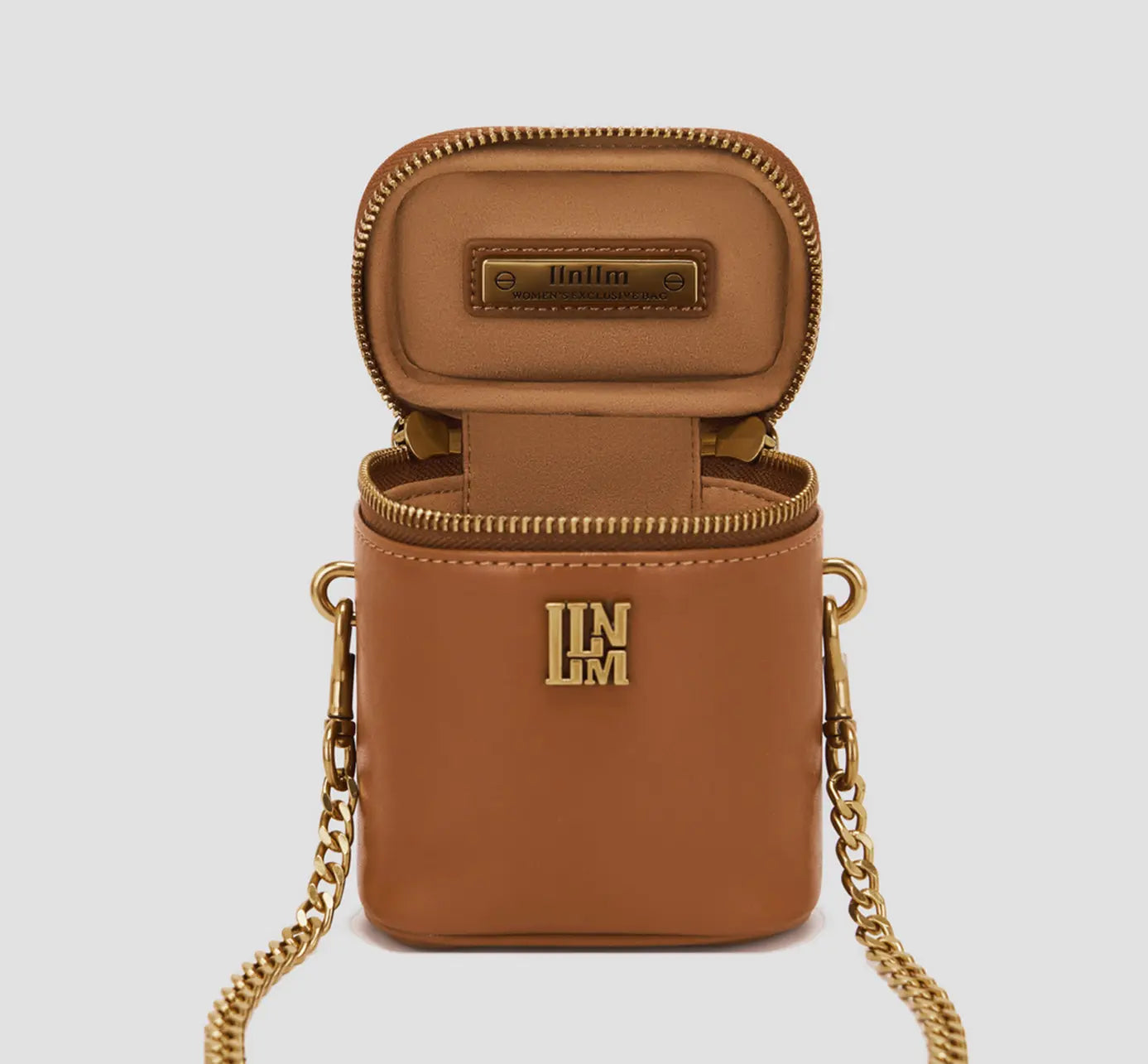 The open-bag interior of a brown box bag with a structured interior and logo detail is a luxury mini-purse for essentials.
