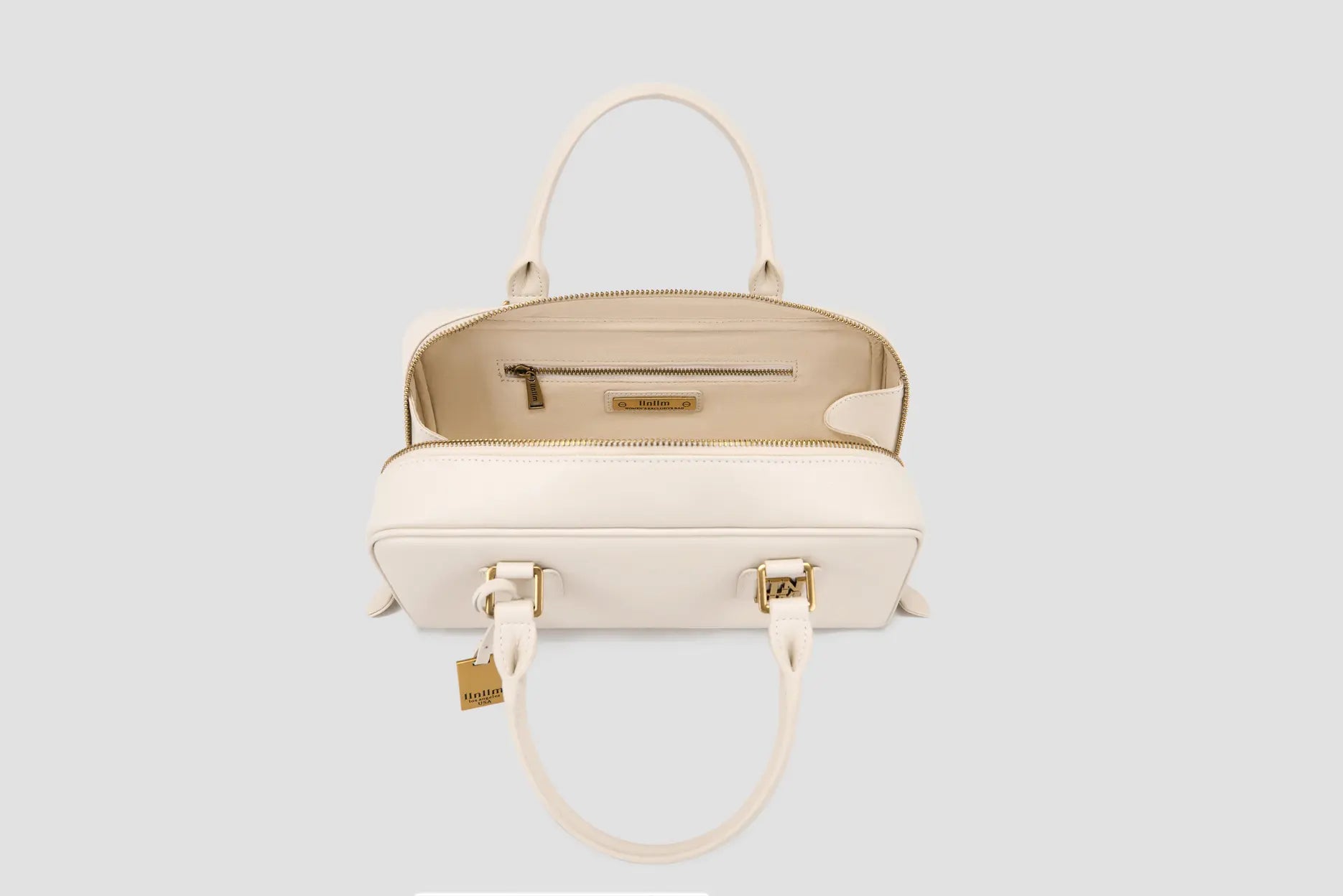 The Interior view of cream leather handbag with zip pocket and branded lining.