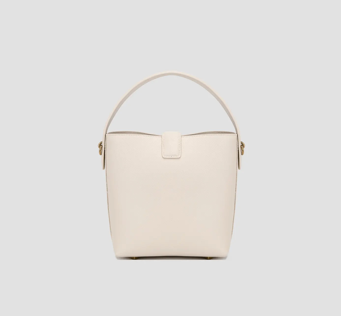 The back view of minimalist ivory leather bucket bag back view – timeless women’s handbag for formal and casual outfits.