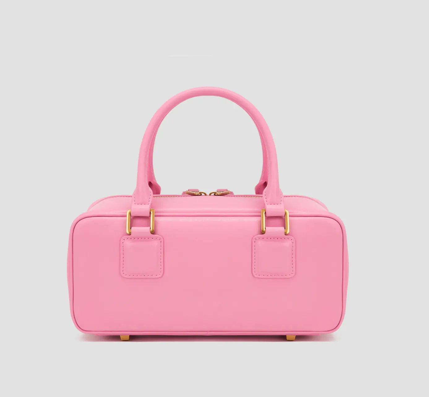 The back view of a pink structured handbag with dual handles—a minimalist affordable luxury purse by Los Angeles fashion label llnllm.
