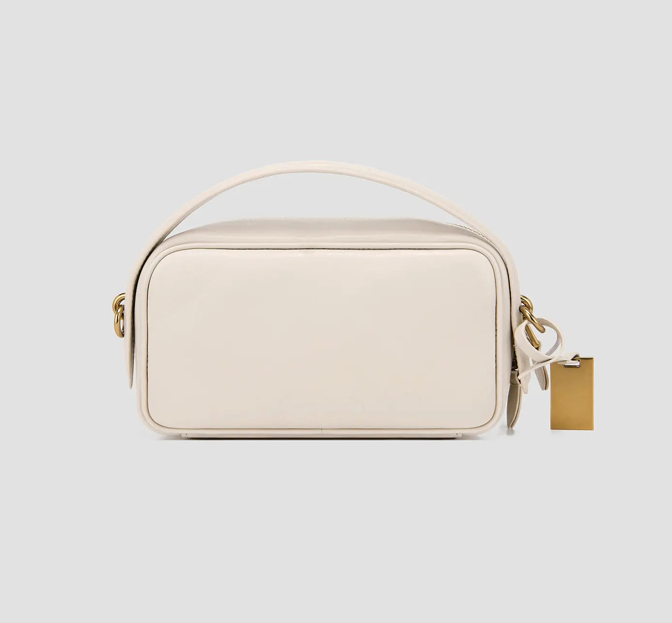 The back view of a small white leather crossbody purse with a top handle and chain strap—a women’s designer mini bag.