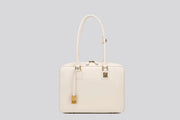 The front view of a white leather structured handbag with gold hardware—an elegant tote bag for women by Los Angeles fashion brand llnllm.
