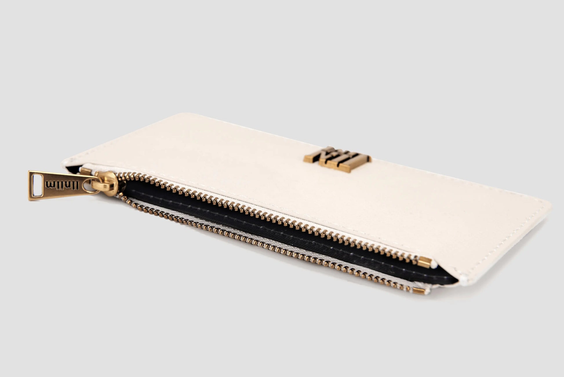 Angled view of white llnllm card holder showing zipper opening.