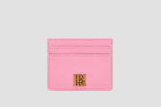 The front view of pink llnllm slim card holder with gold logo accent.
