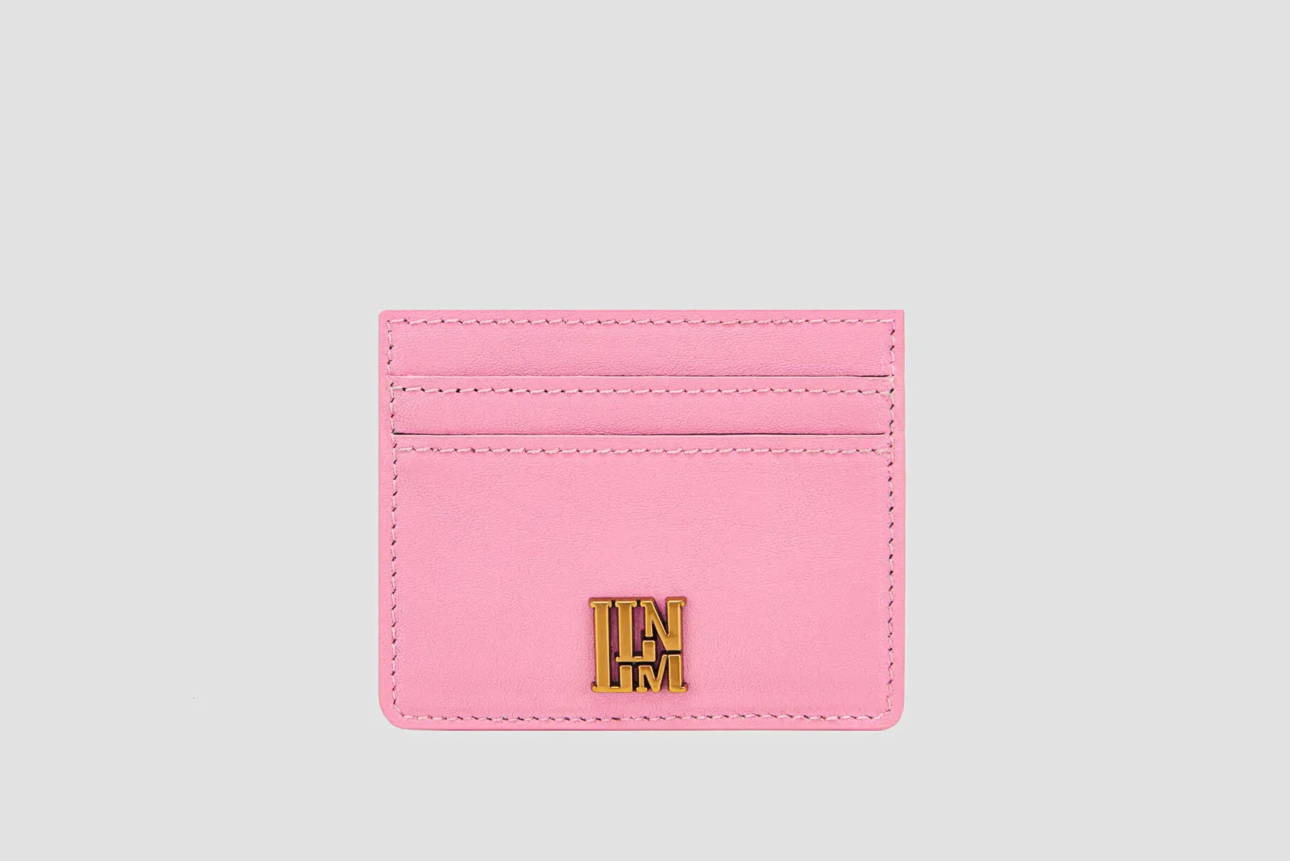 The front view of pink llnllm slim card holder with gold logo accent.