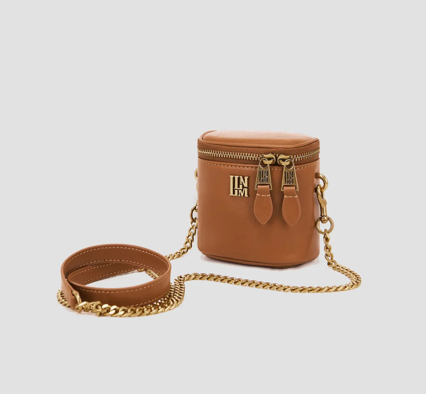 The angled front view with strap wrapped
Stylish brown vegan leather cube purse with golden zipper – trendy crossbody bag for women on the go.
