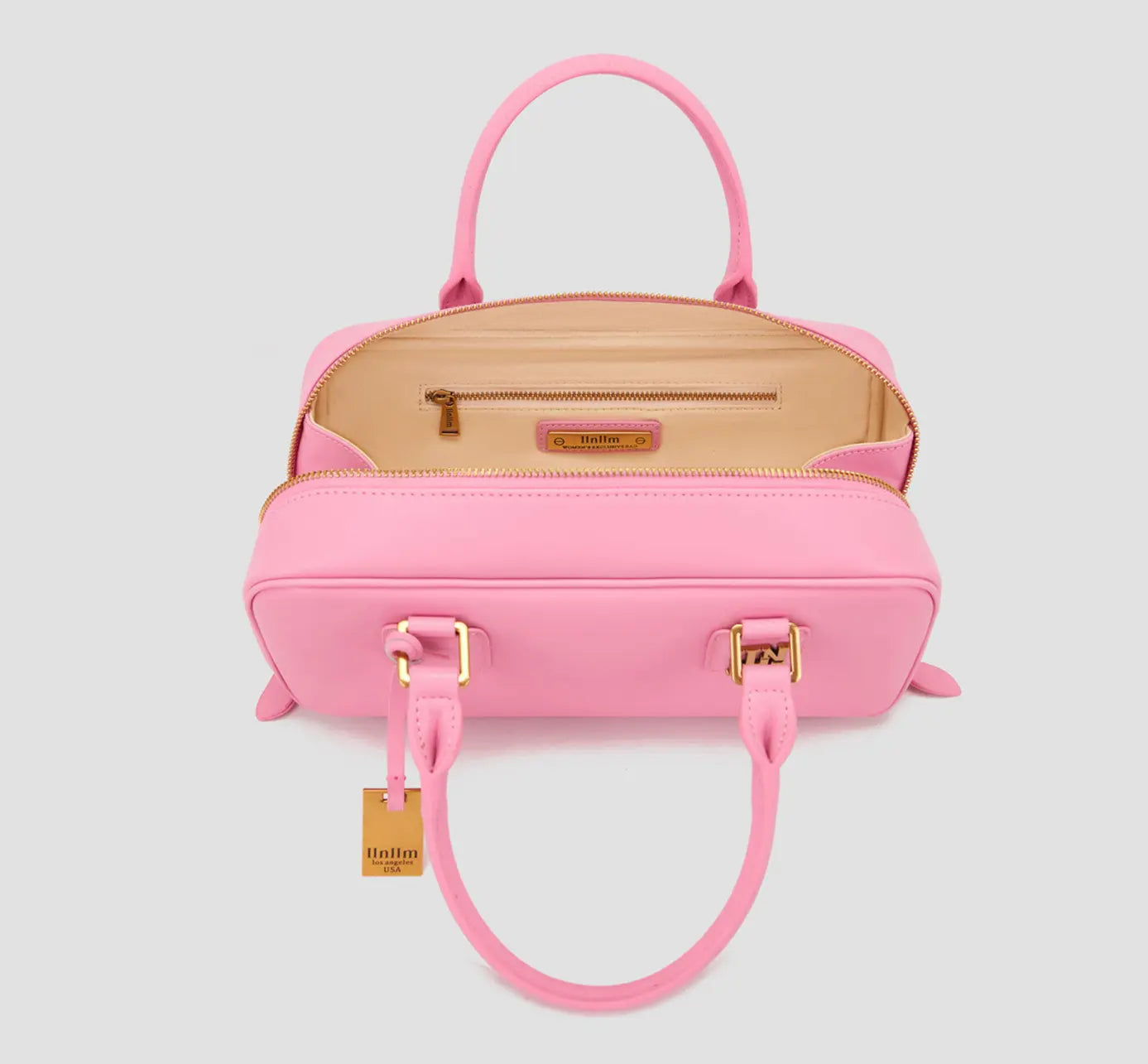The interior of llnllm pink handbag with zip pocket and beige lining – elegant and functional women’s purse from Los Angeles-based affordable luxury brand.