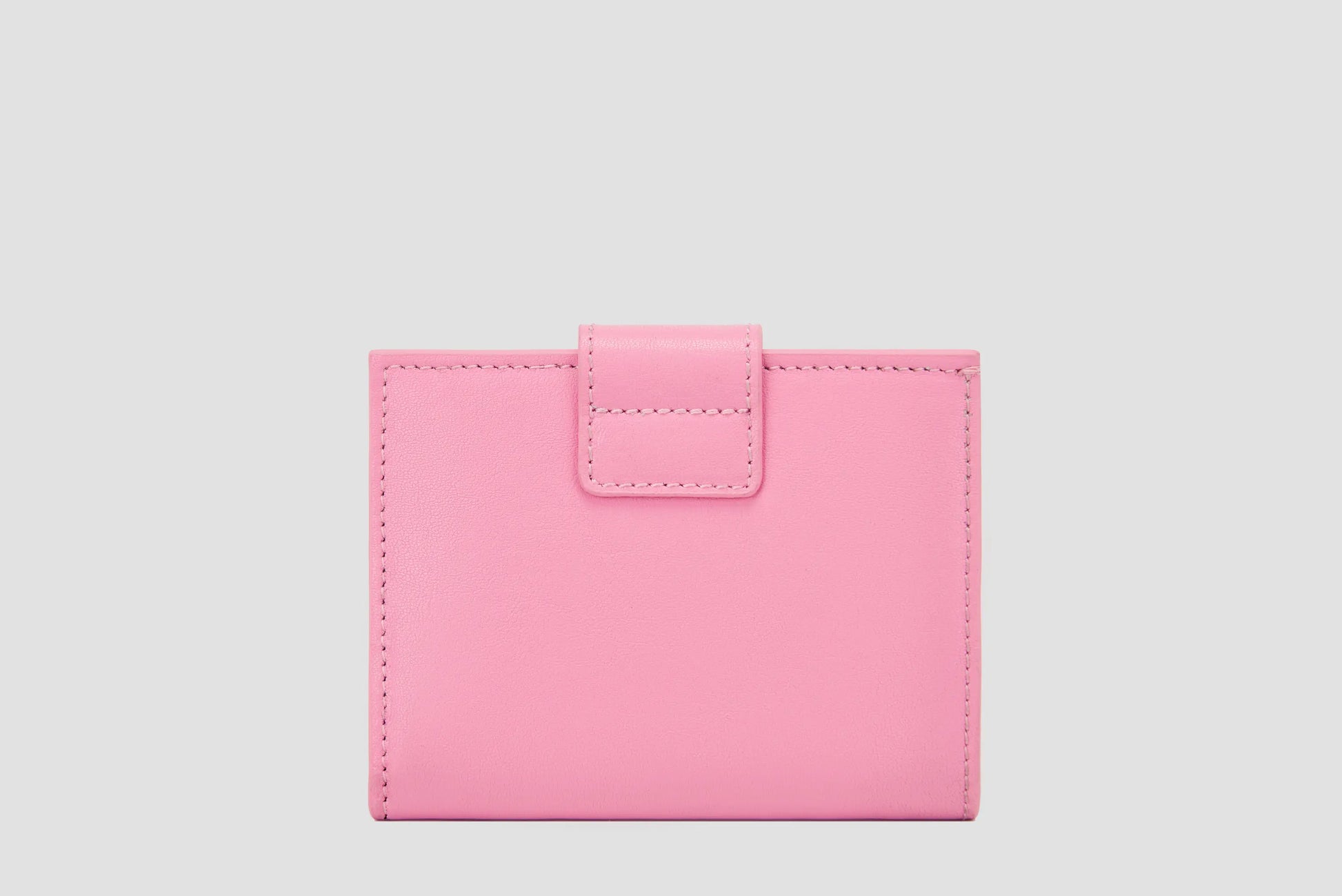 Back view of pink llnllm leather wallet, smooth finish and stitched edges.