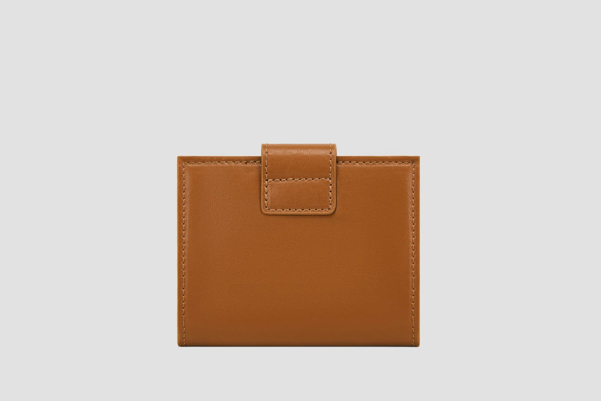 The back view of tan llnllm leather wallet, smooth stitched finish.