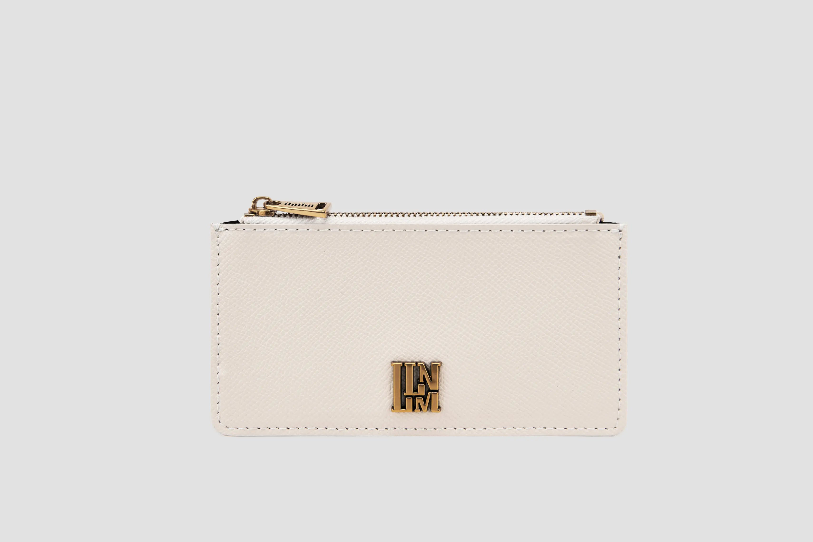 White textured leather llnllm card holder with gold zipper and logo.