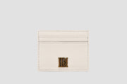 White leather llnllm slim card holder with gold logo, modern style.